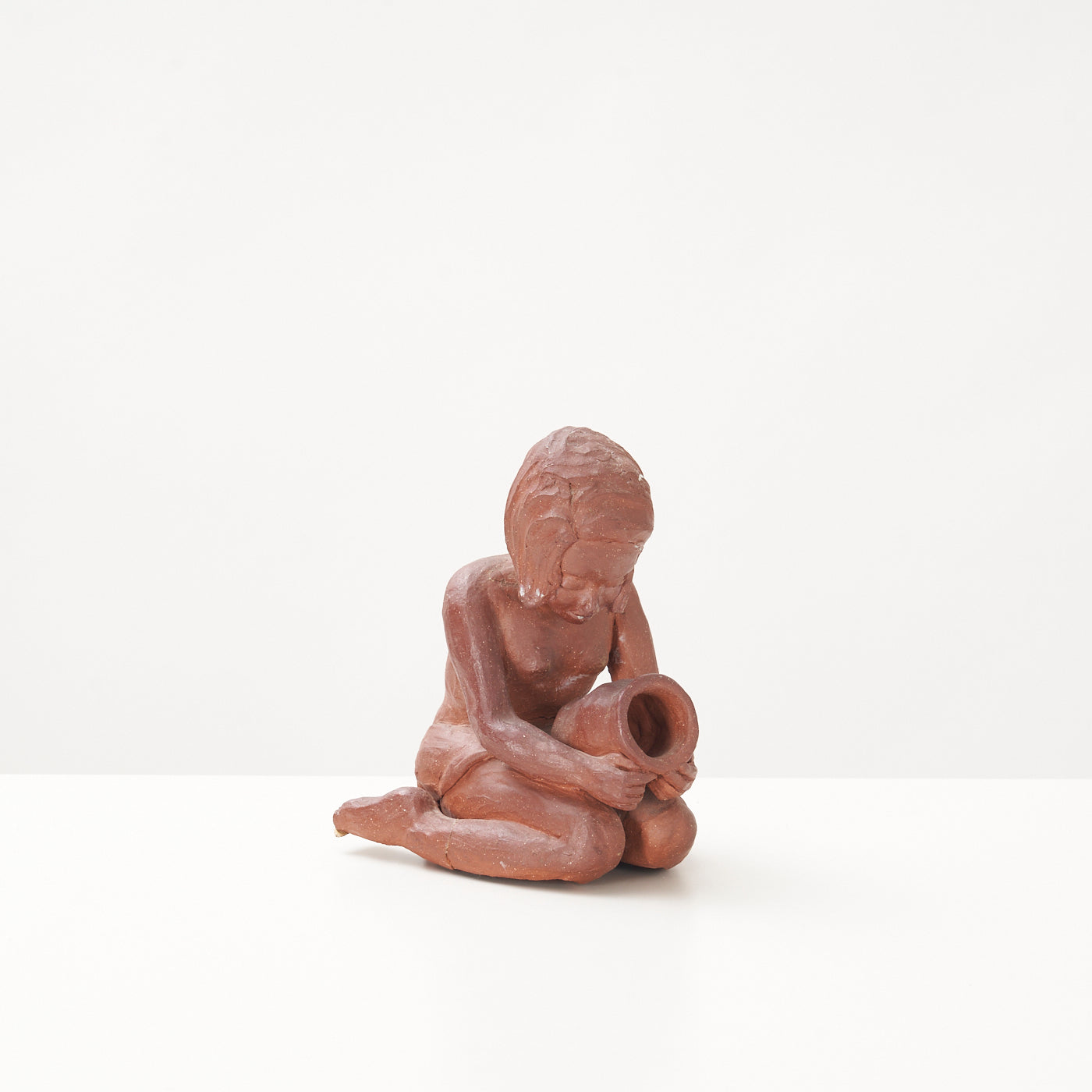 Red Clay Kneeling Child Figurine